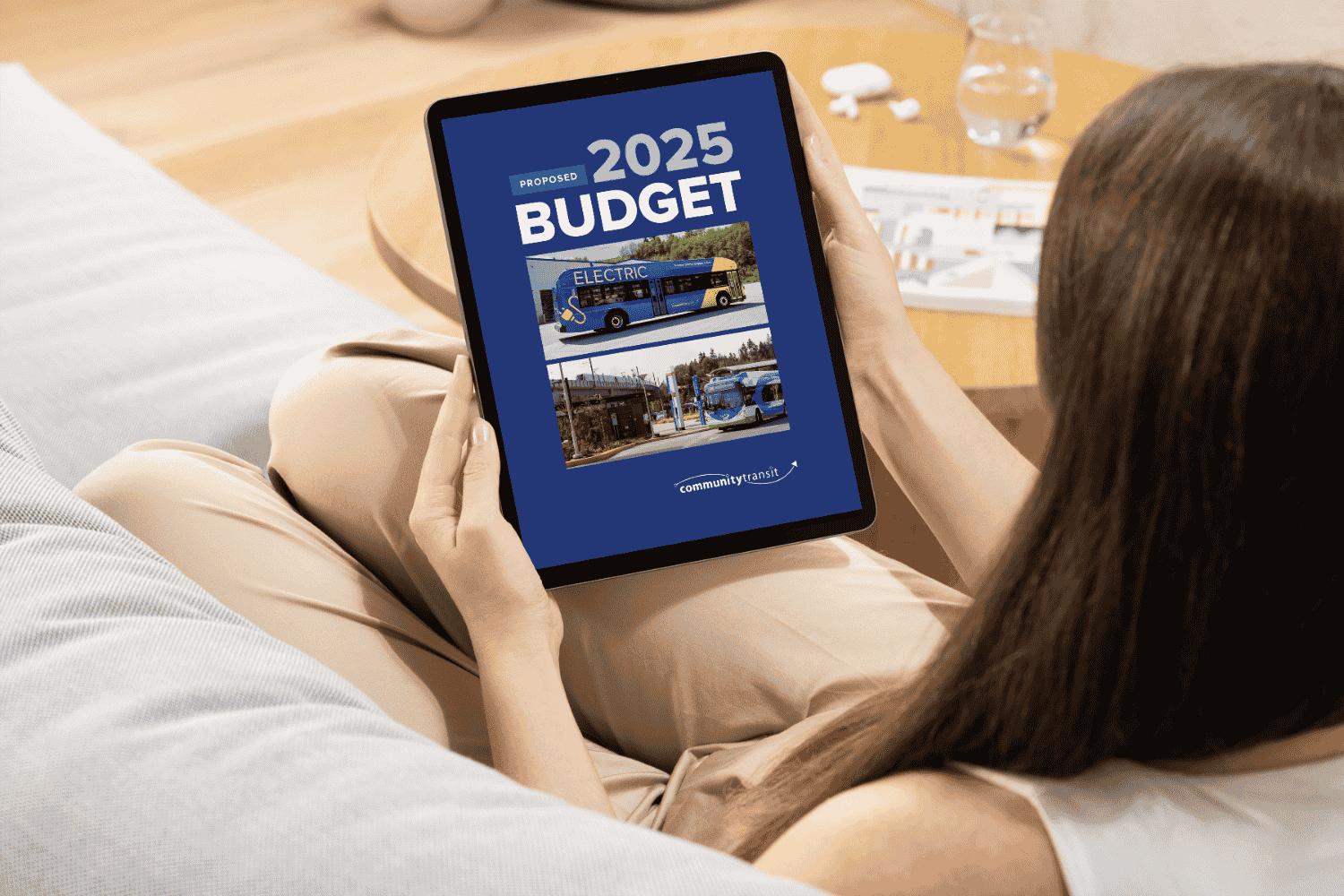 A woman views the cover of Community Transit's 2025 Proposed Budget on her tablet.