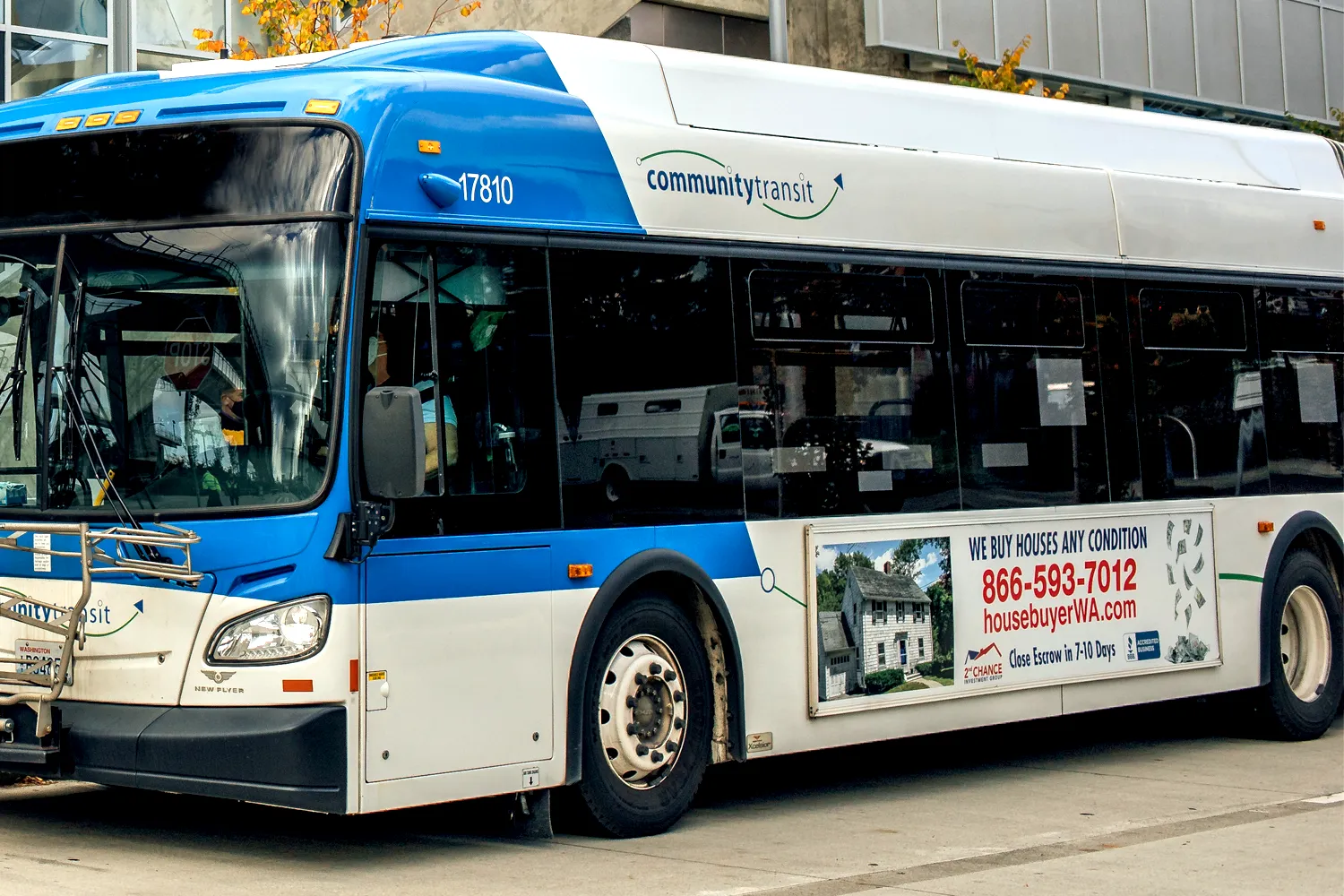 a Community Transit bus with an advertisement posted on the site