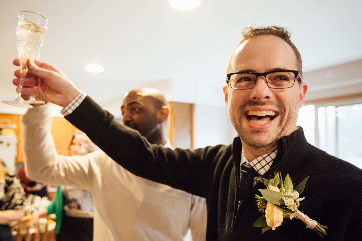Second image: Phillip Jefferies (front) and Lance Lewis are shown smiling and toasting their union at their wedding.  