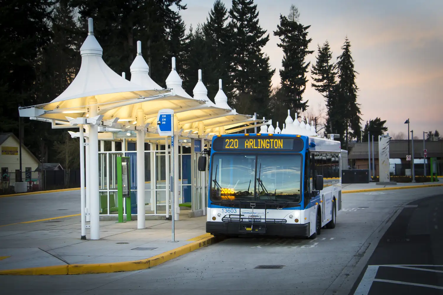 a group of transit riders waiting on a station platform