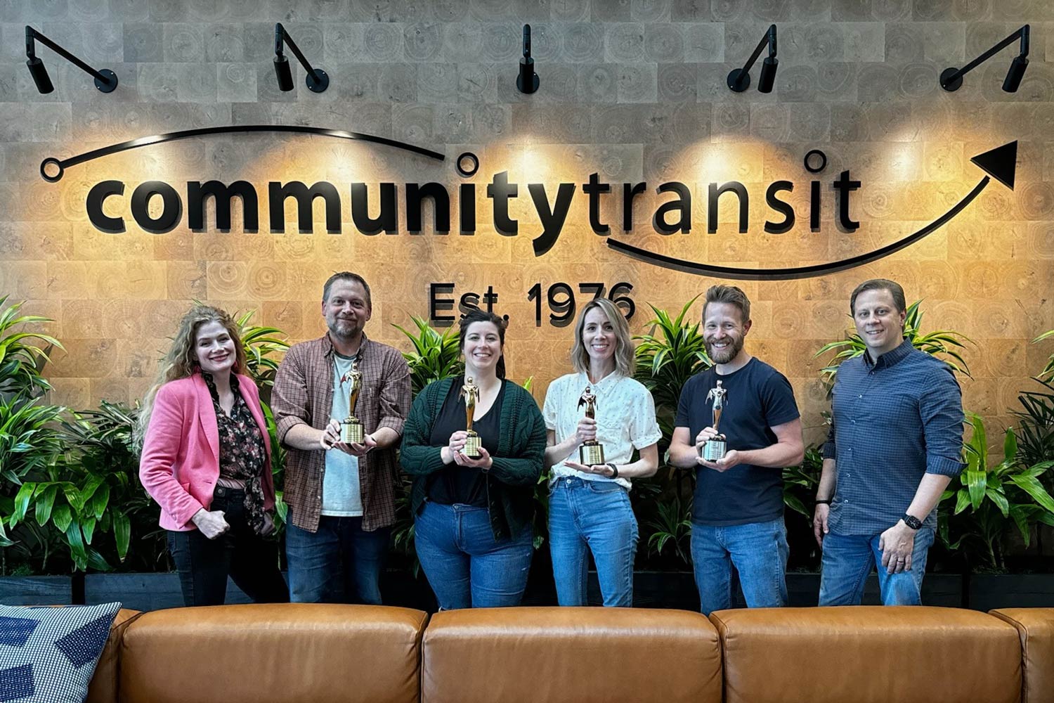 The Creative & Brand Team smiles with their four Telly Awards.