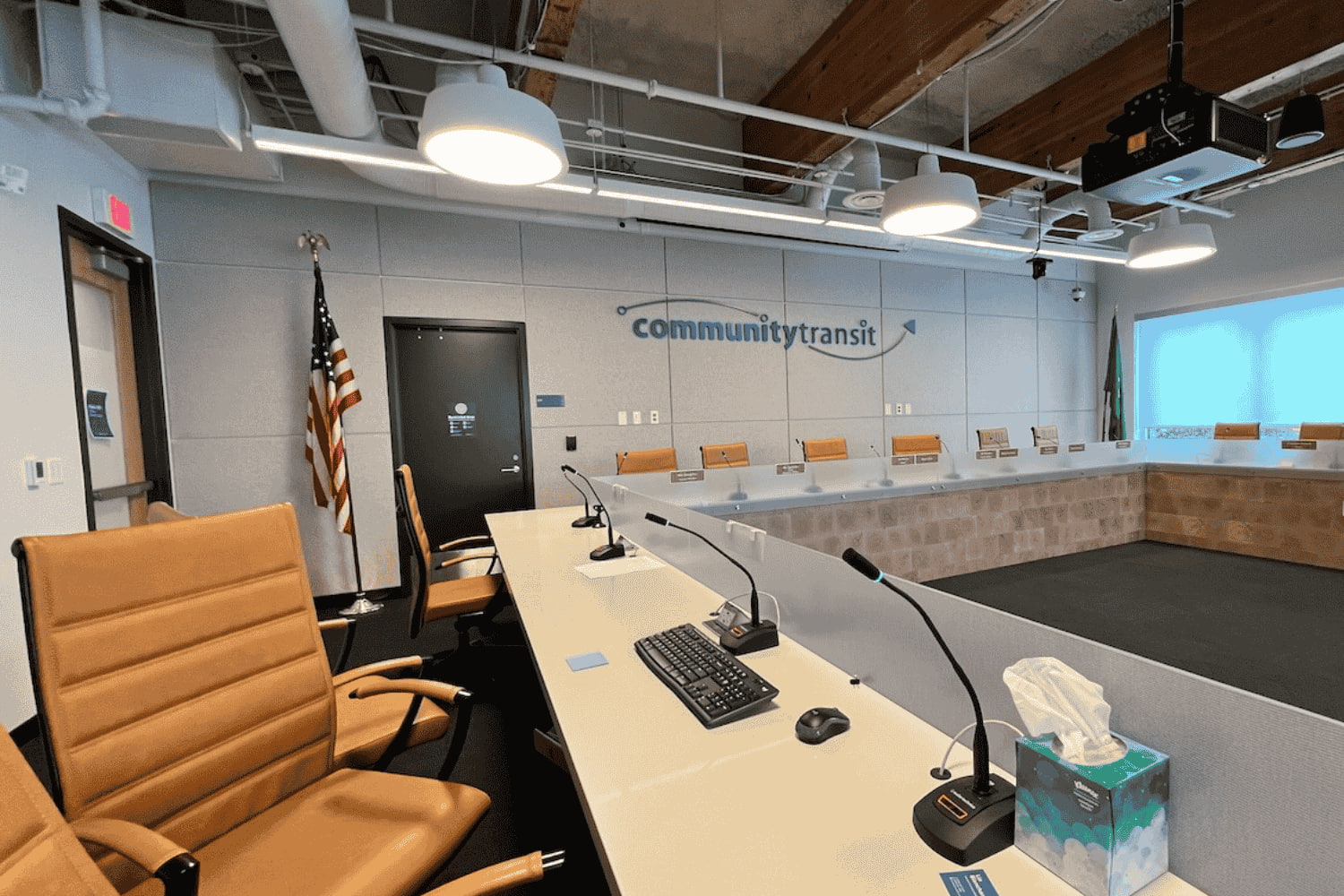 A shot of the dais in Community Transit's board conference room. Tan leather seats are empty.