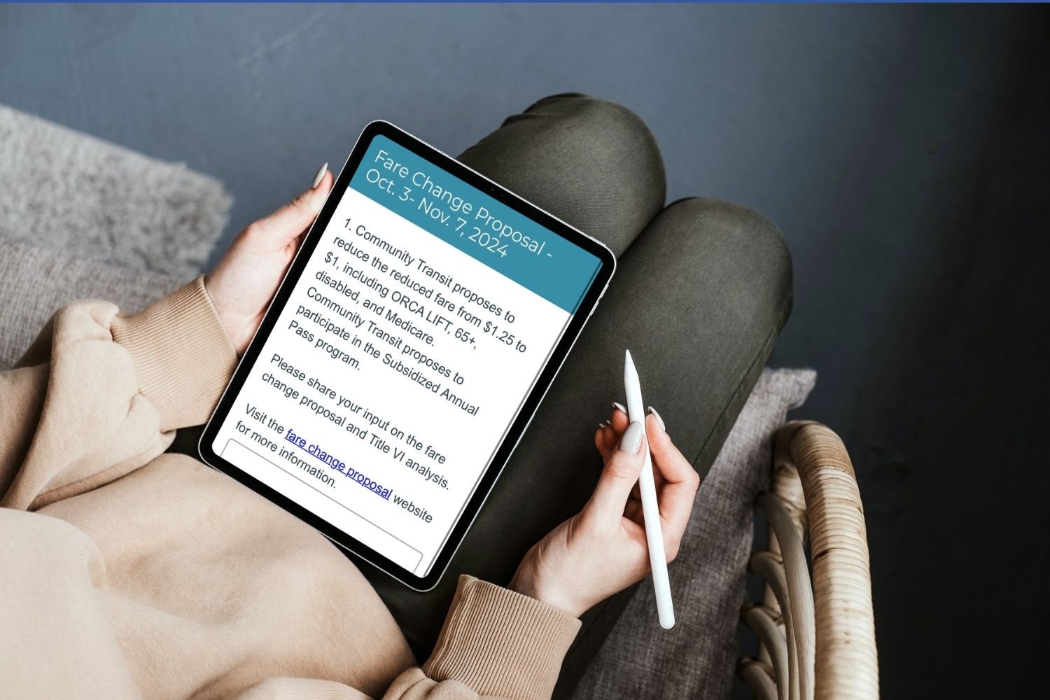 A person uses a tablet to view an online survey about CT's fare change proposal