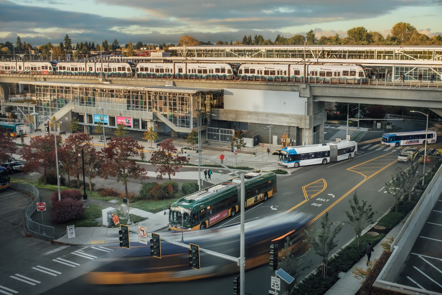 A scene from Northgate Station showing buses from CT and KCMetro. Link lightrail is on the elevated tracks.