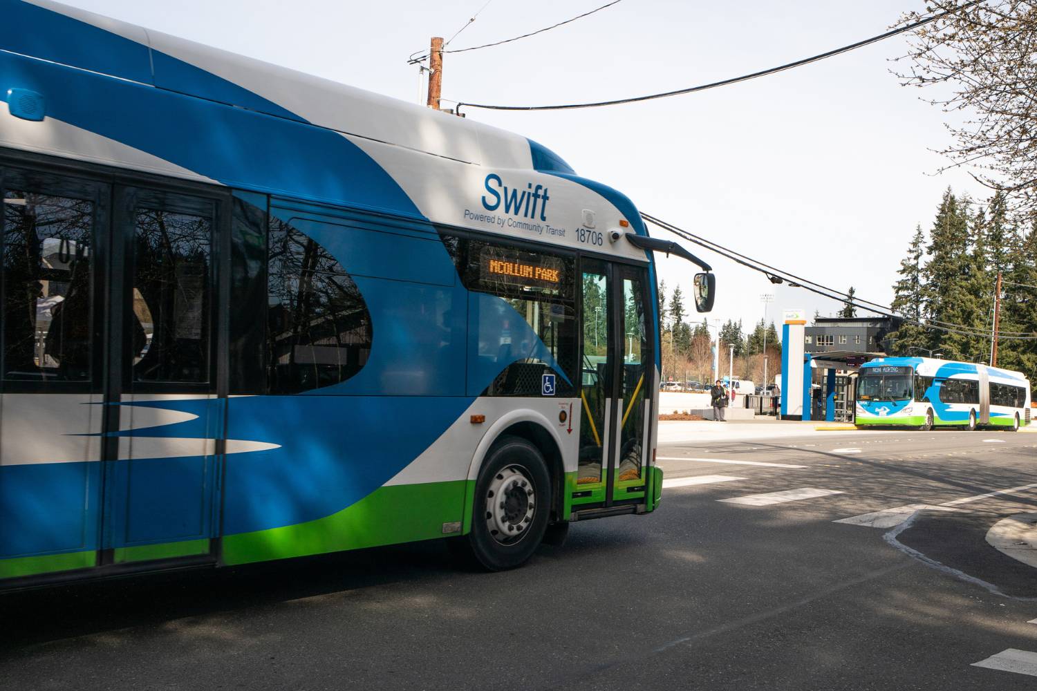 Two Swift buses travel in opposite directions near Edmonds College