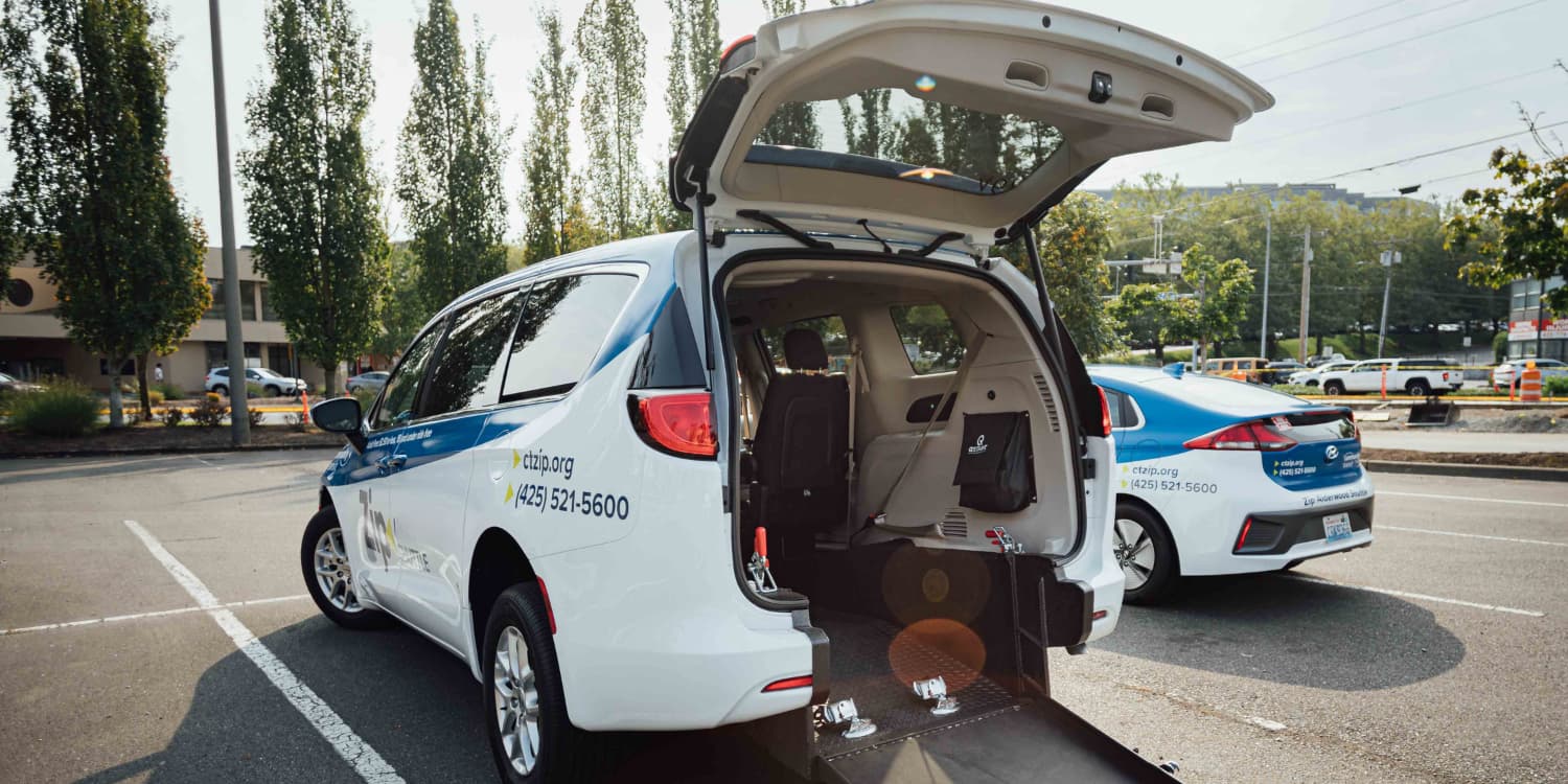 Zip shuttle van with back door open with mobility ramp extended