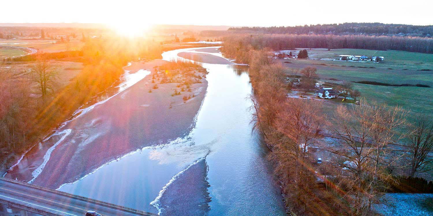 an aerial view of farmland and the Stillaguamish River in Arlington, WA