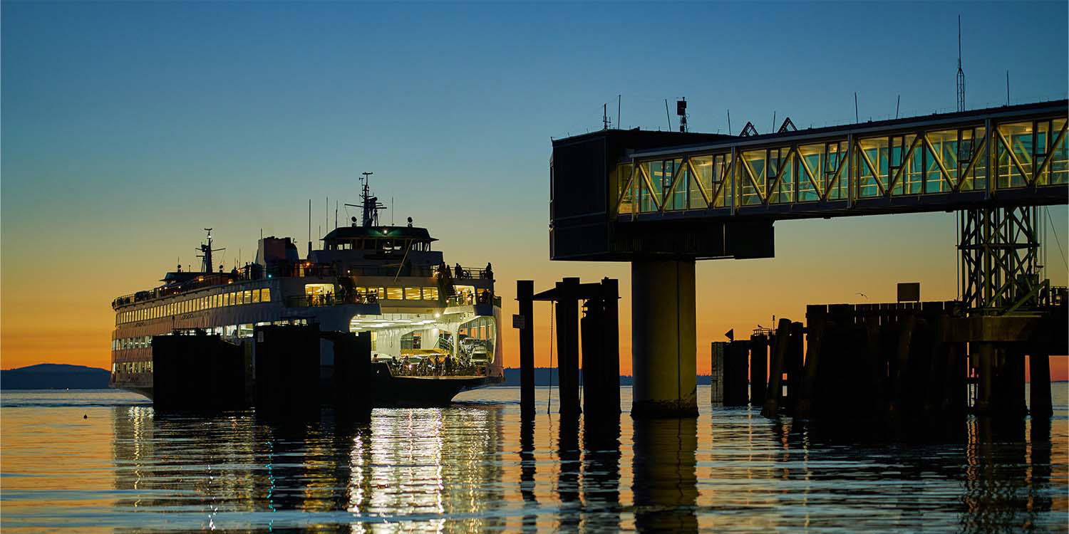 a ferry arriving at the terminal at dusk in Edmonds, WA