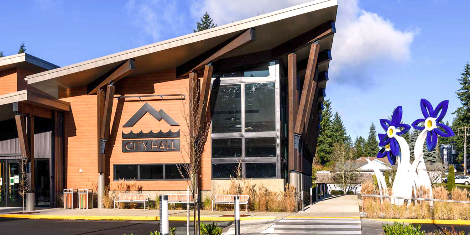 a photo of Mountlake Terrace city hall building with flower sculpture art installation