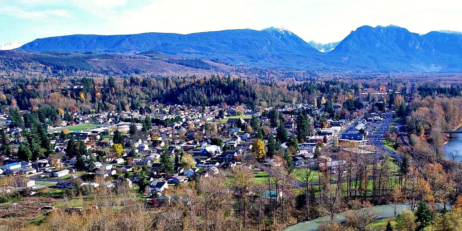 an aerial view of Sultan, WA with mountains in the background