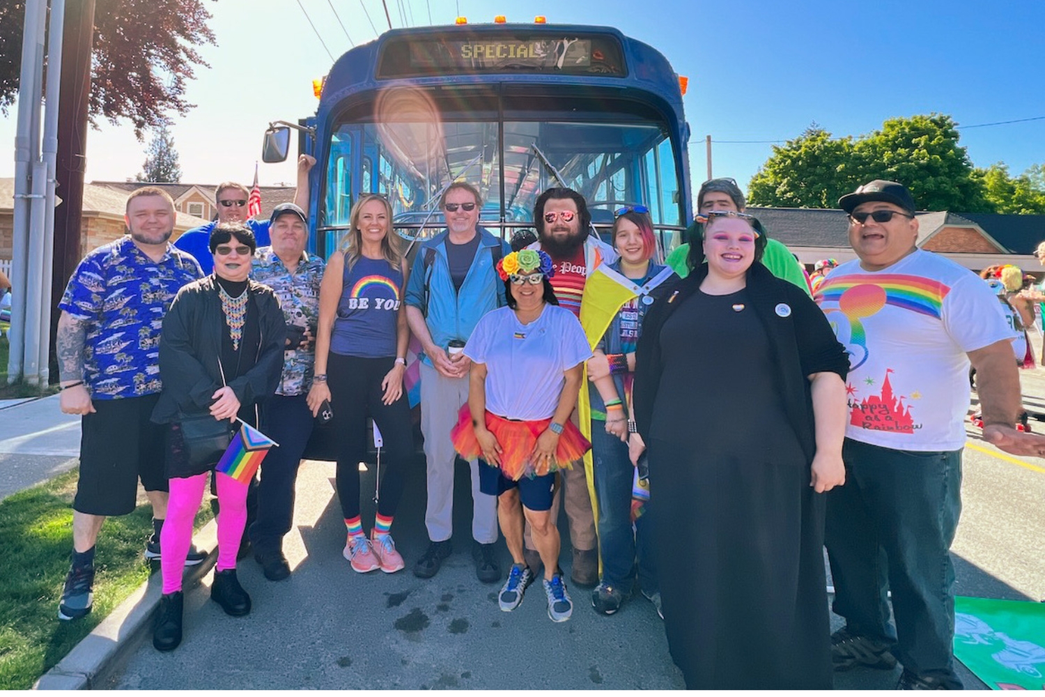 People smile in front of a CT Bus at the first Snohomish Pride Fest