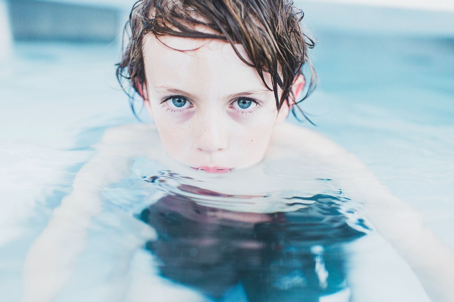 A child swimming in the pool.