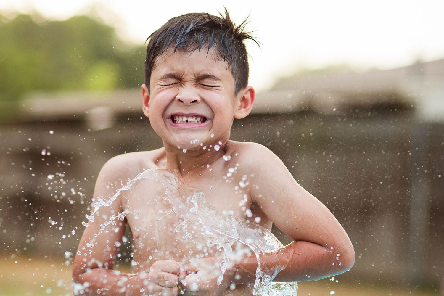 Child plays at spray park.