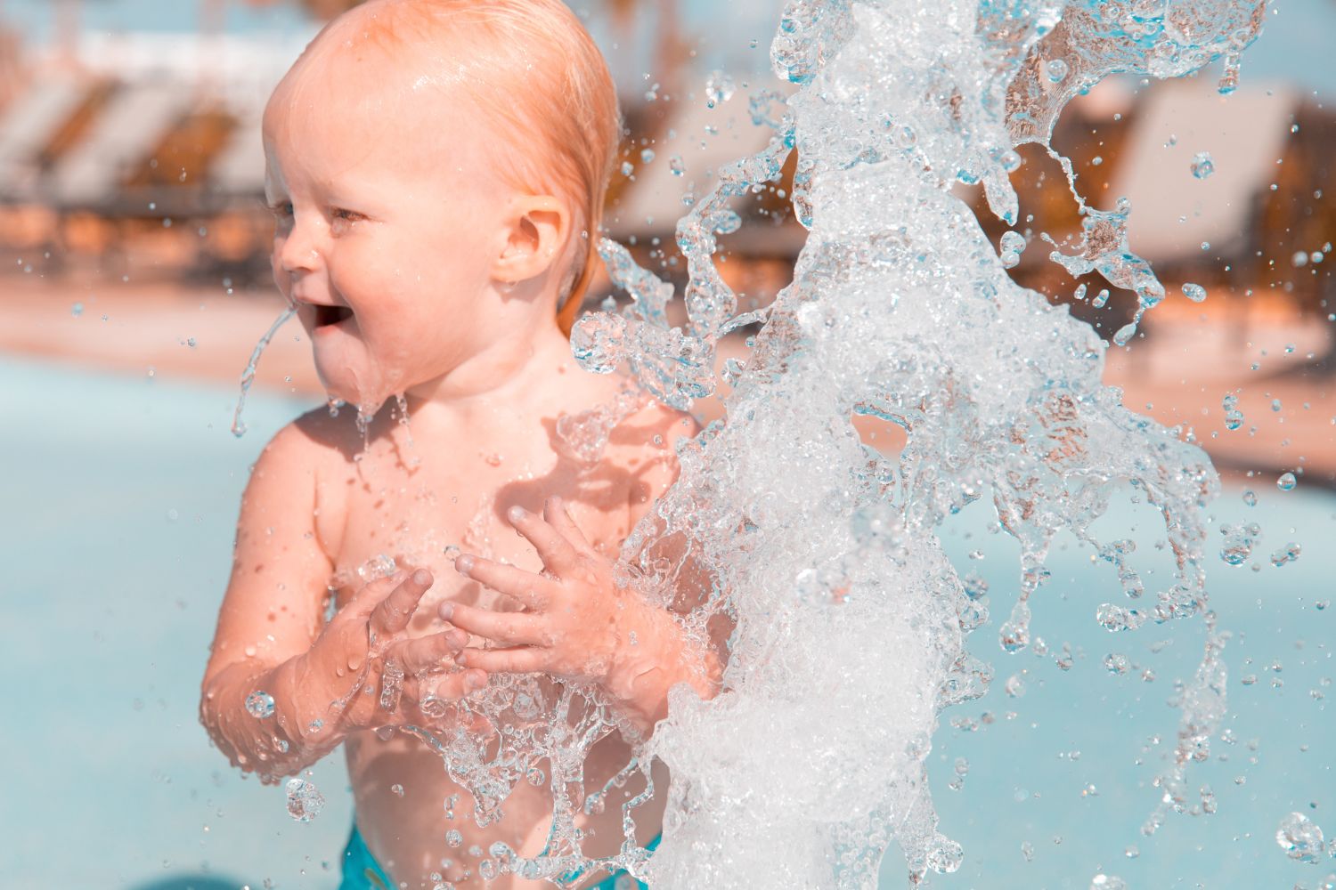 Toddler having fun at the splash pad.