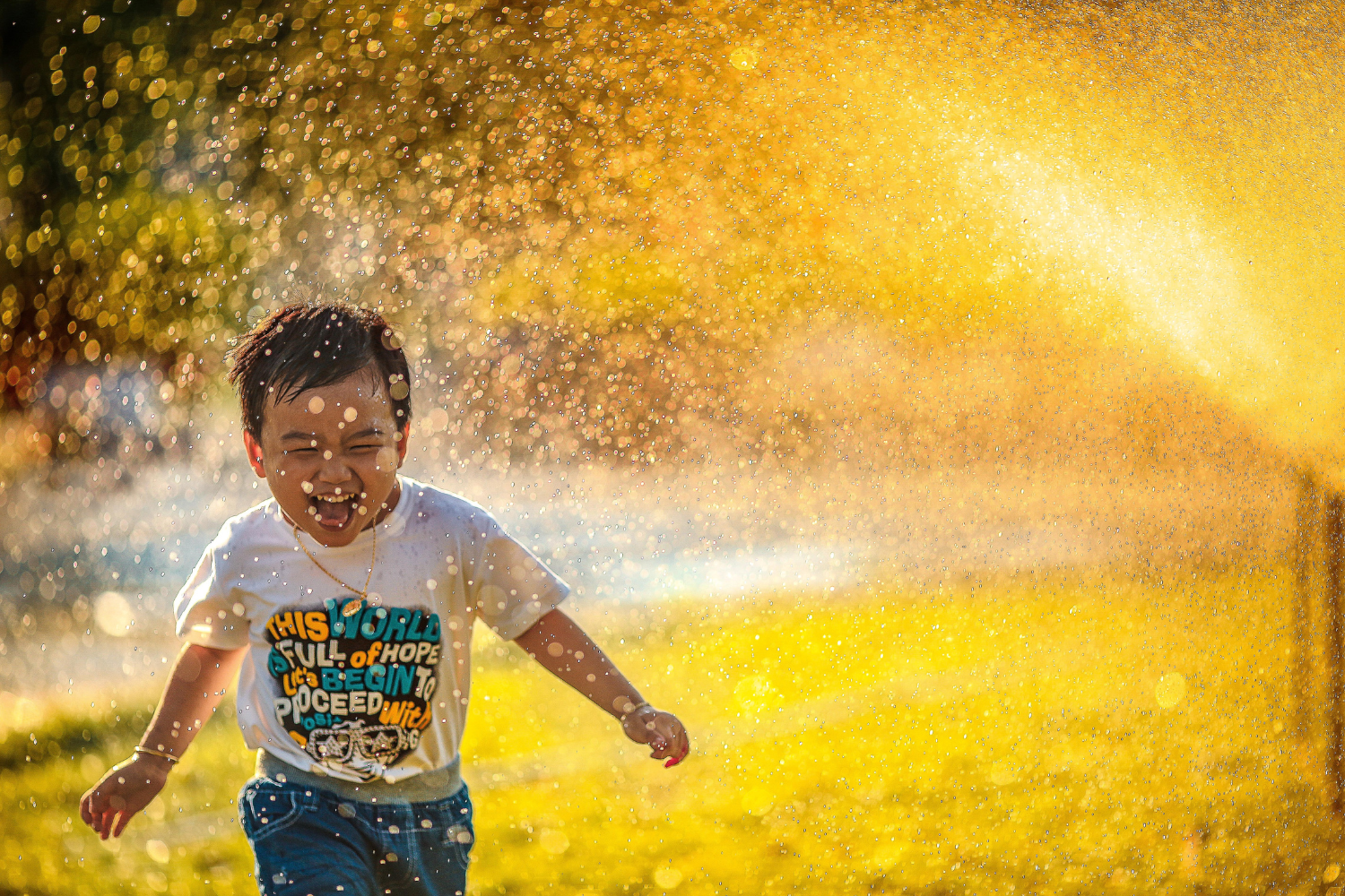 Child laughing at spray park