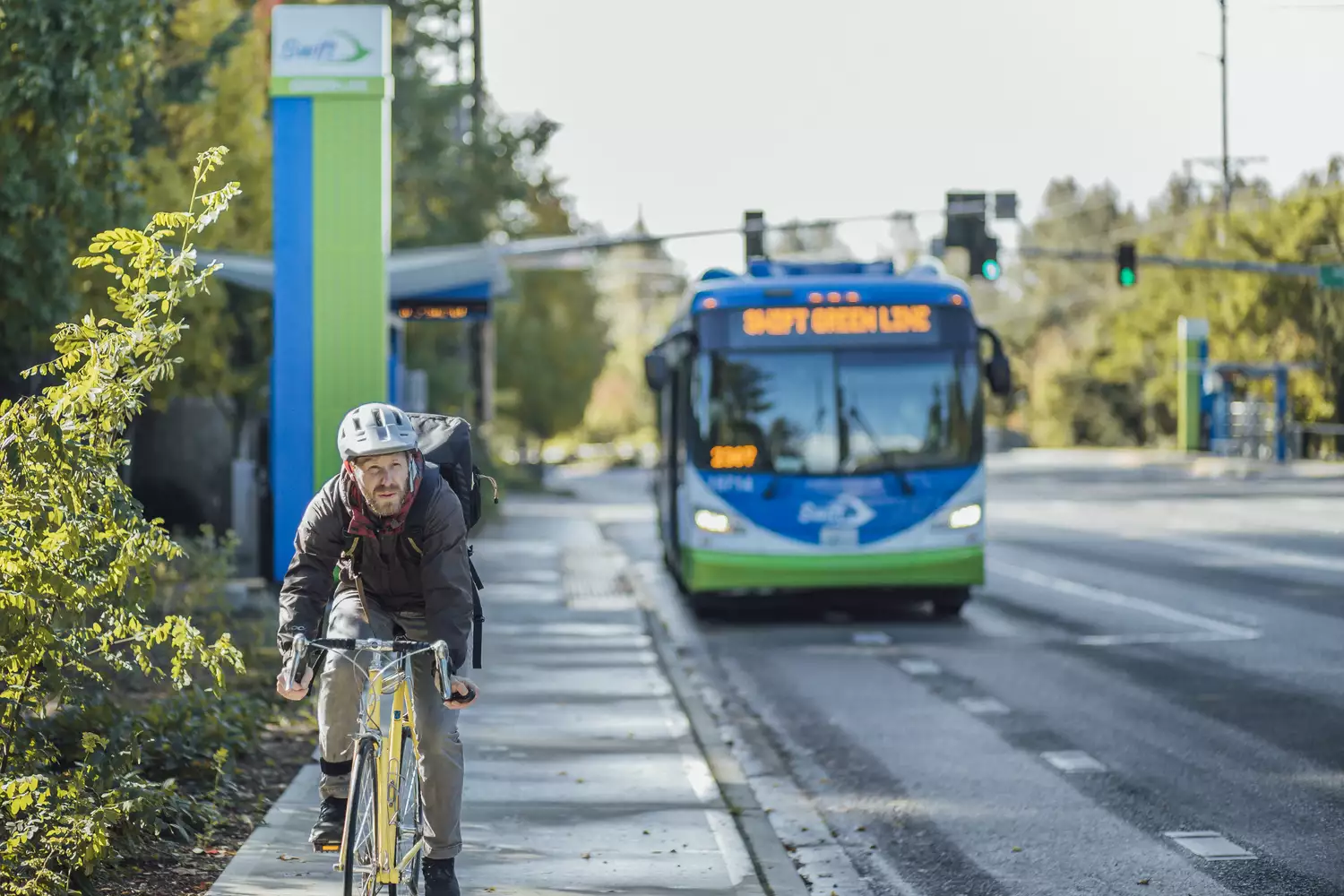 A biker connects to a Swift bus.