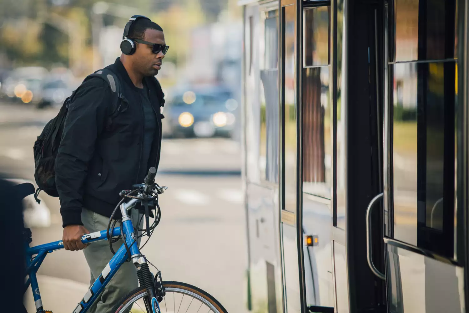 A man boards a bus with his bike.