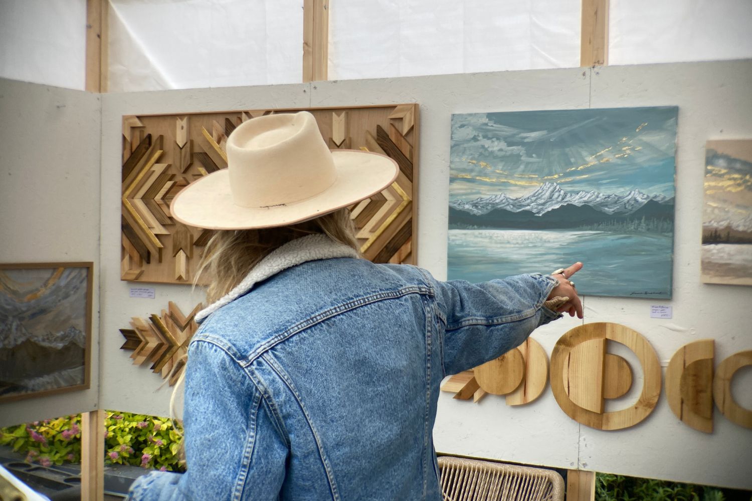 An image of an artists showing her work at the Edmonds Art Festival