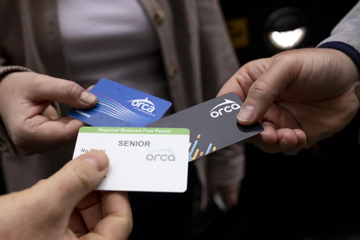 three riders comparing different ORCA cards together