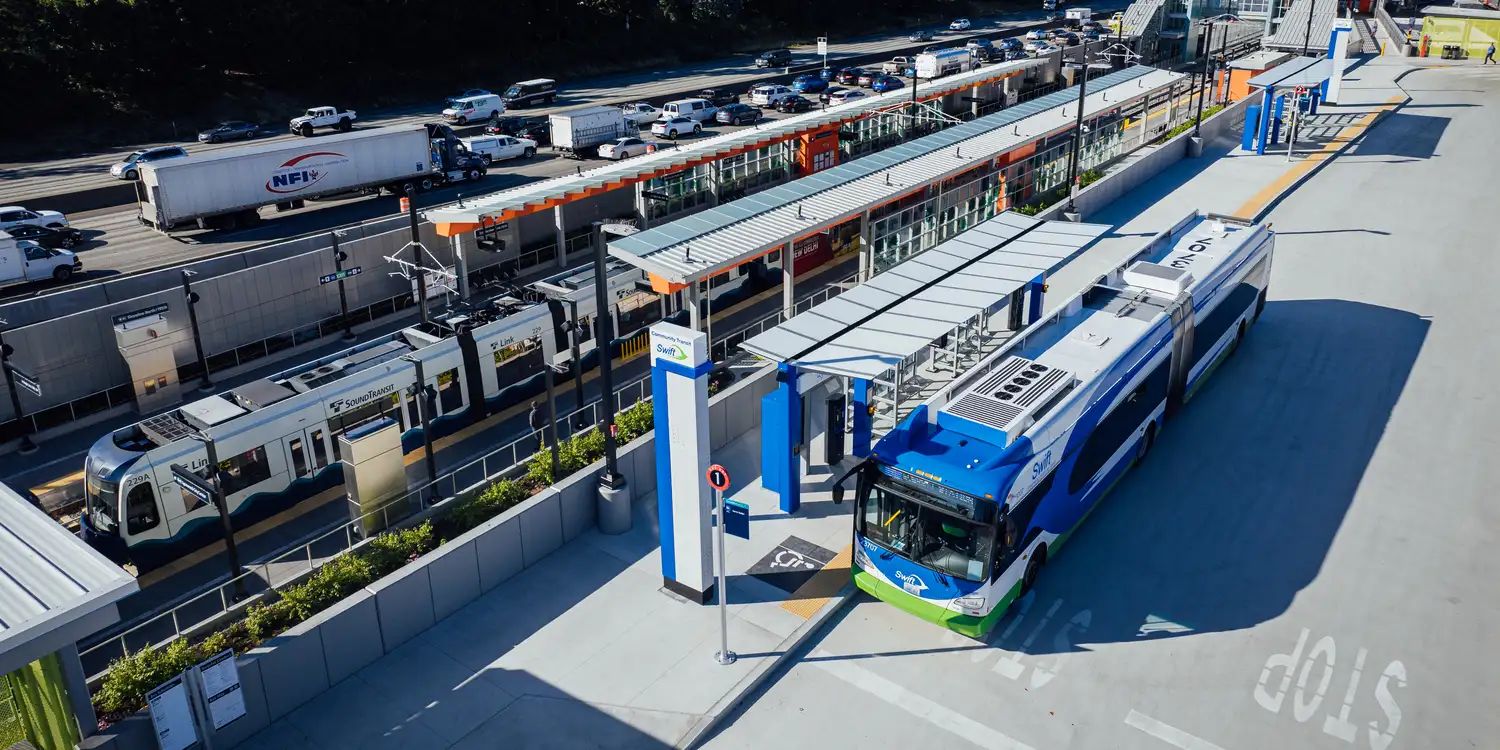 an aerial photo of a Link light rail train and Community Transit bus at Shoreline North Station