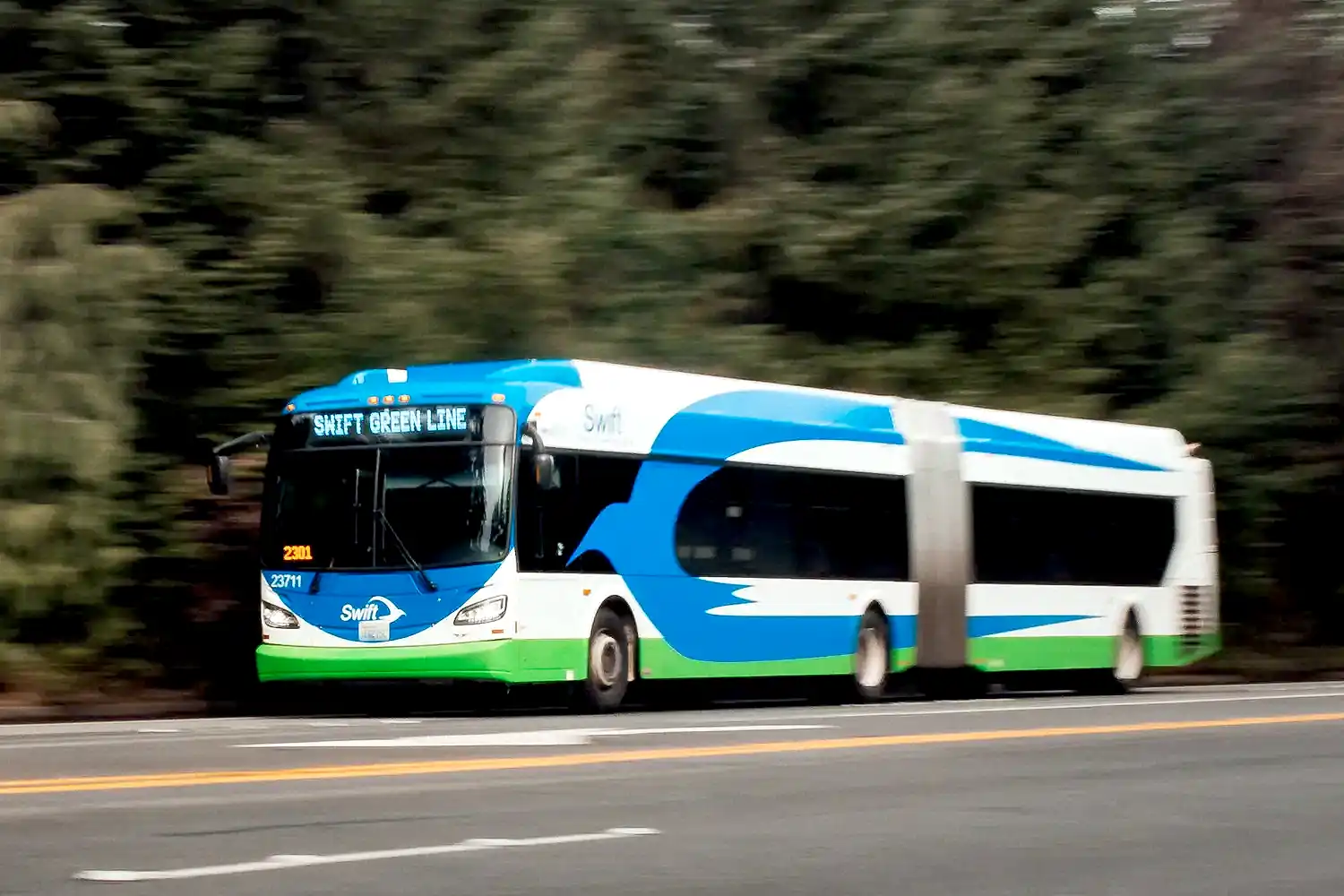 Swift buses a Swift Green Line bus travelling down a road