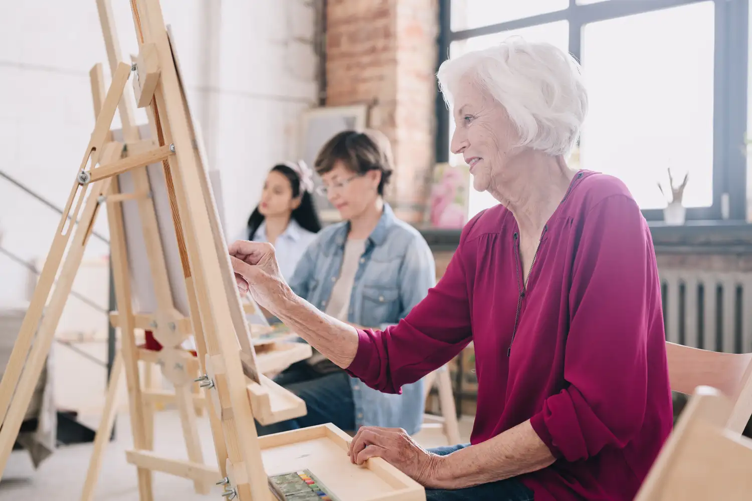 an older woman participating in an art class