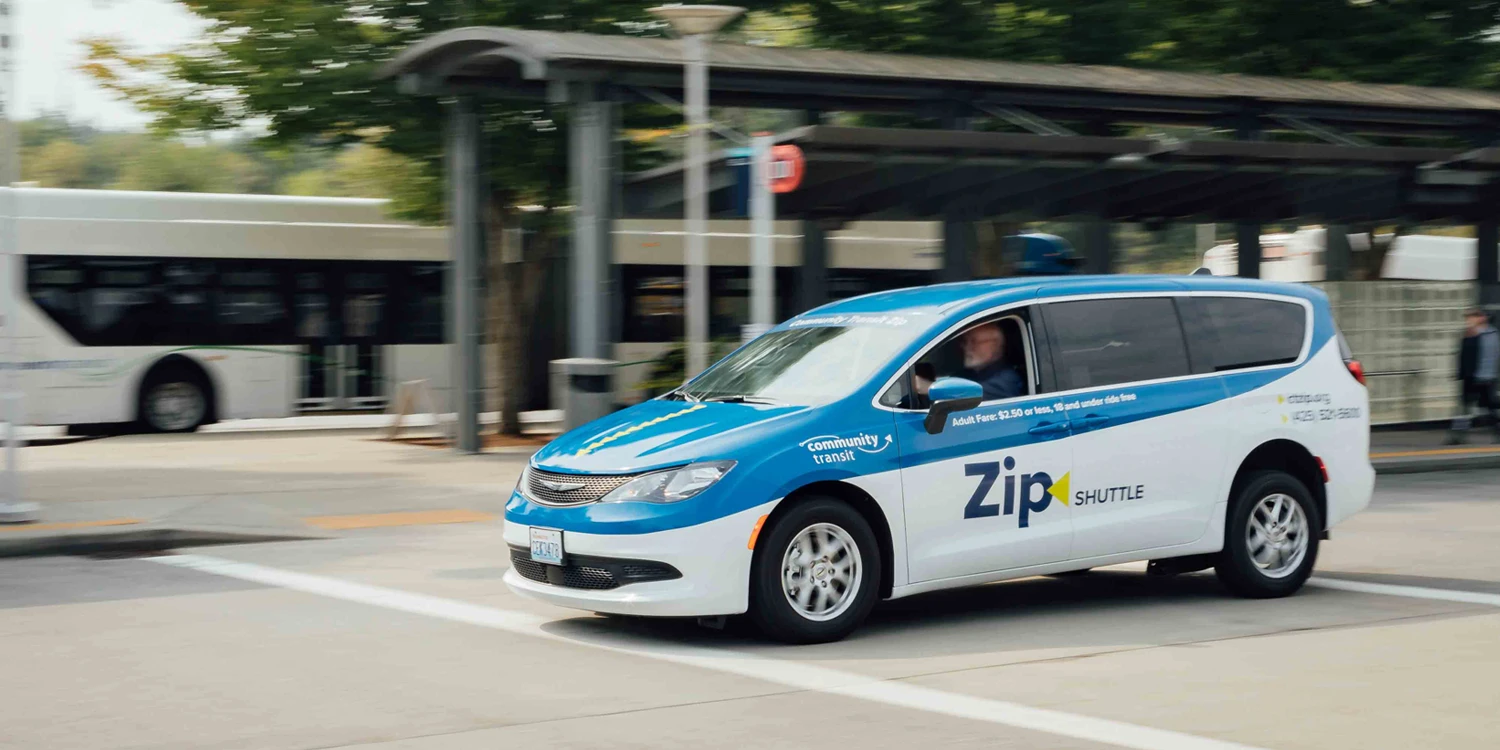 A Zip Shuttle rideshare vehicle at a transit center