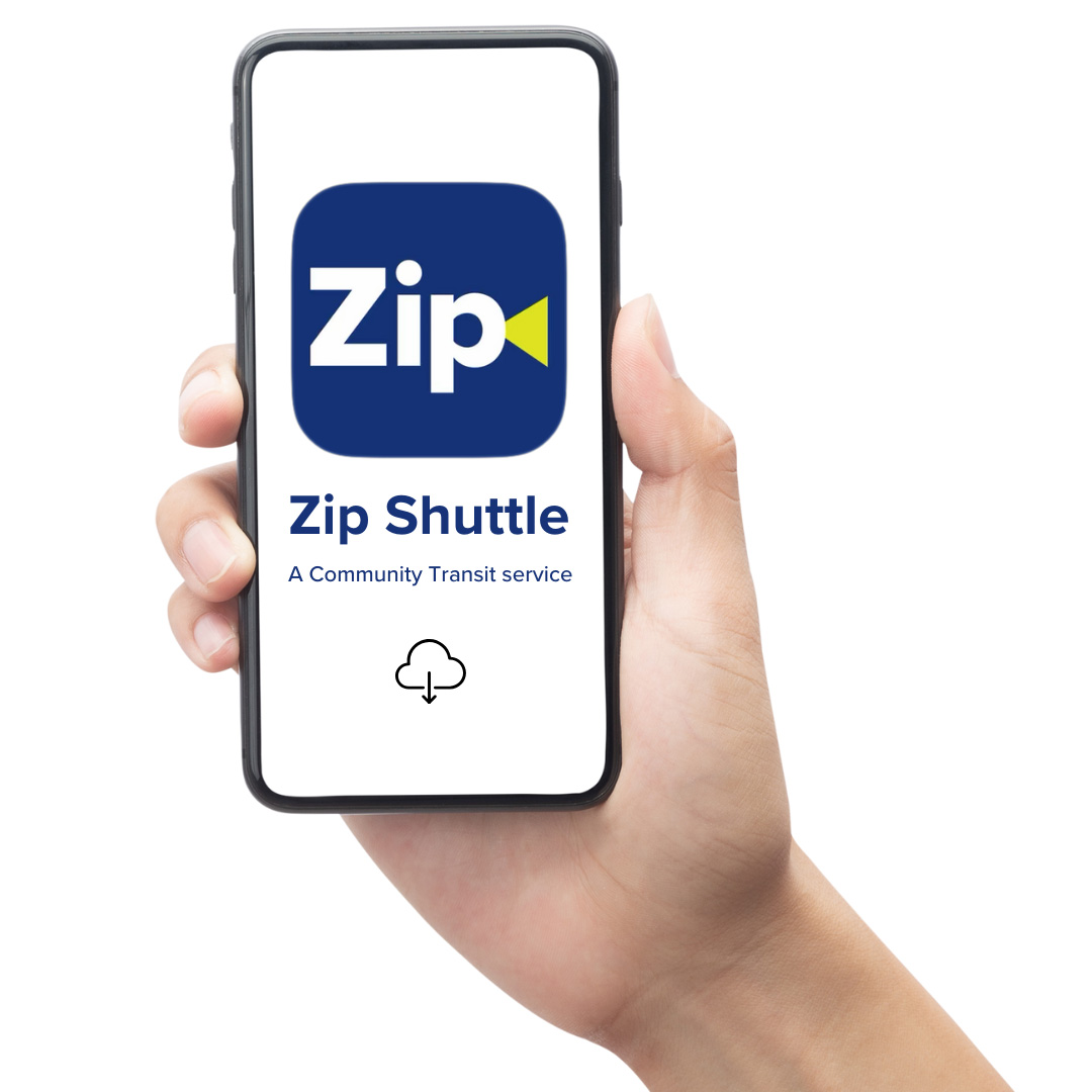 a hand holding a phone displaying the Zip Shuttle app icon