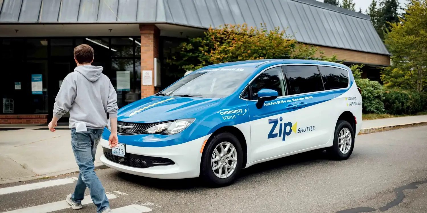 a Zip shuttle van dropping off a rider